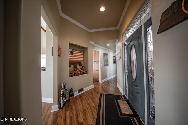 interior space with ornamental molding and dark hardwood / wood-style floors