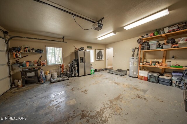 garage featuring electric water heater, a garage door opener, and stainless steel fridge