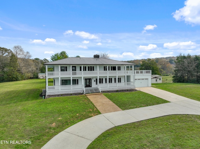 view of front facade with a garage, a front yard, and a porch