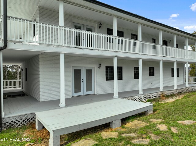 rear view of property featuring french doors and a balcony