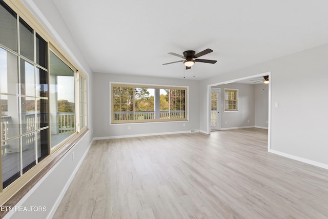 unfurnished room with light wood-type flooring and ceiling fan