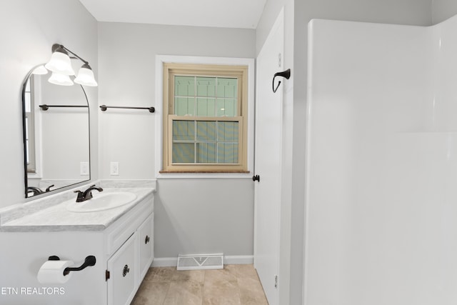 bathroom with tile patterned flooring and vanity