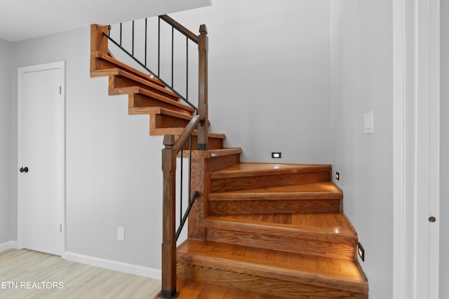 stairs with hardwood / wood-style floors