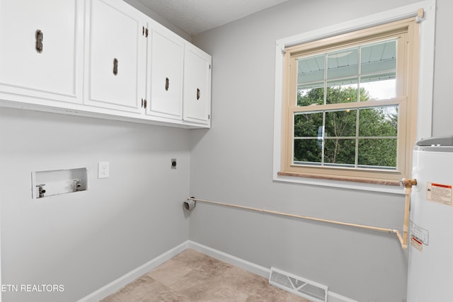 washroom with cabinets, gas water heater, a textured ceiling, electric dryer hookup, and hookup for a washing machine