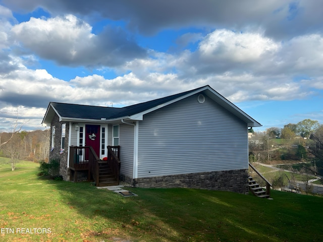 view of side of home featuring a lawn