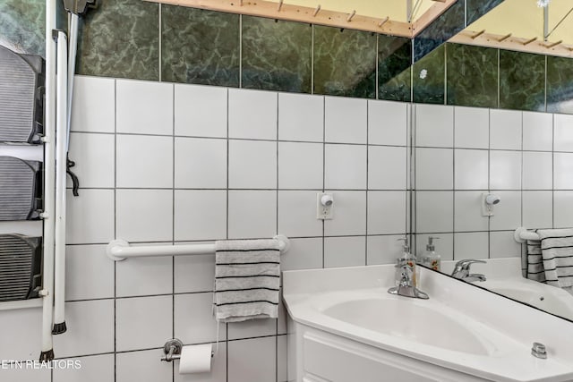 bathroom with vanity and tile walls