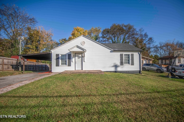 view of front of home with a carport and a front lawn