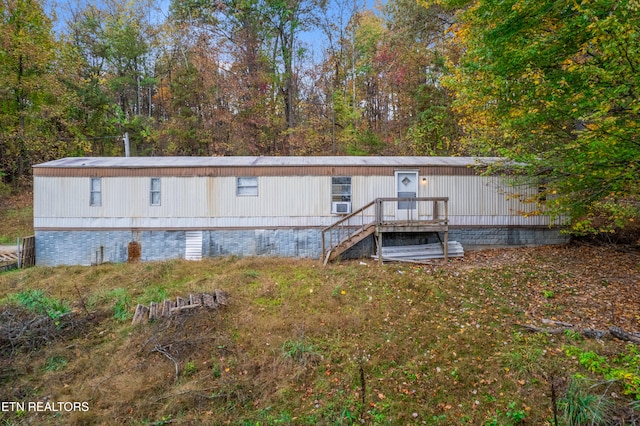 back of house featuring a wooden deck