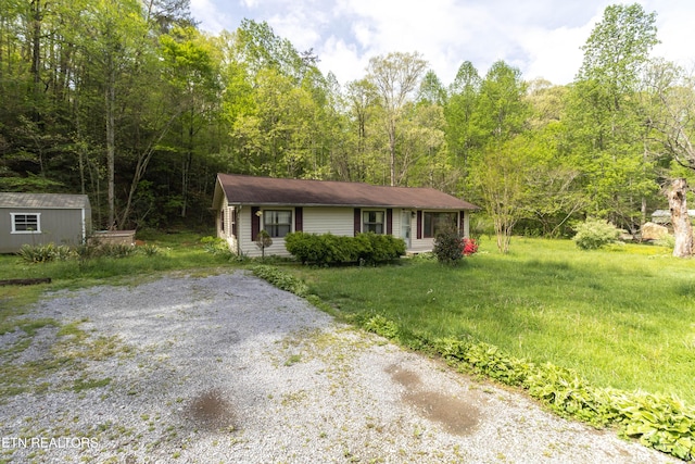 3398 Bell Rd, Sevierville, TN 37862 - view of front of property with an outdoor structure, driveway, and a wooded view