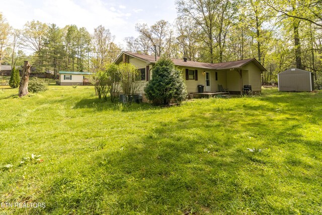 3398 Bell Rd, Sevierville, TN 37862 - back of property featuring an outdoor structure, a yard, and a shed
