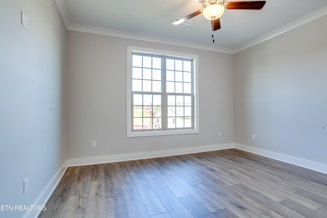 empty room featuring ceiling fan, light hardwood / wood-style flooring, and ornamental molding