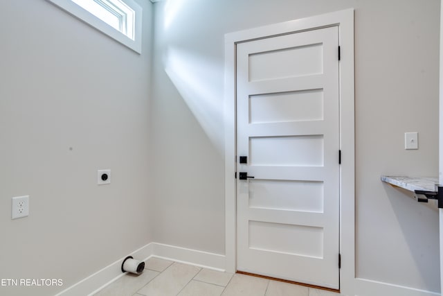 doorway with light tile patterned floors