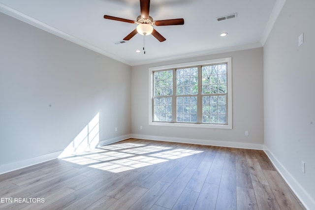 empty room with ornamental molding, light hardwood / wood-style flooring, and ceiling fan