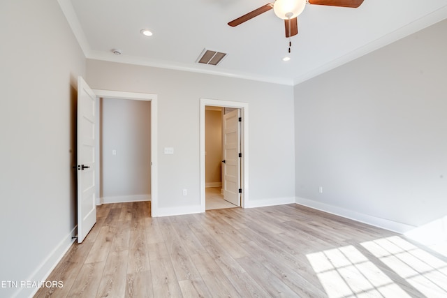 unfurnished bedroom with ensuite bathroom, light hardwood / wood-style floors, ornamental molding, and ceiling fan