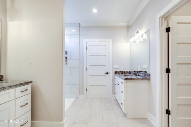 bathroom with vanity, tile patterned floors, and a tile shower