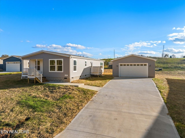 view of front of home featuring a garage, an outdoor structure, and a front yard