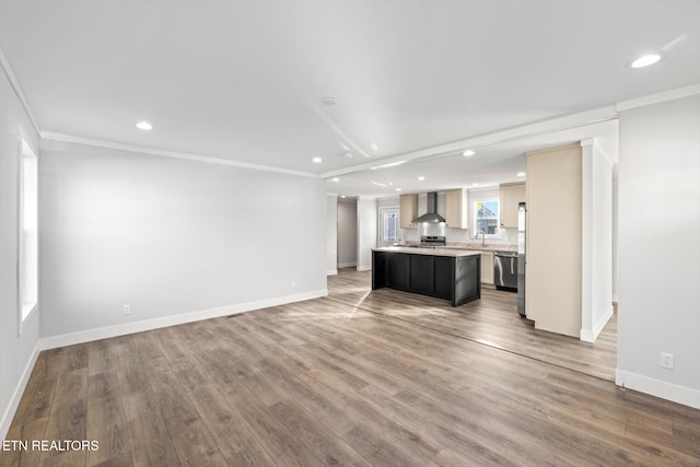 unfurnished living room featuring hardwood / wood-style flooring and ornamental molding