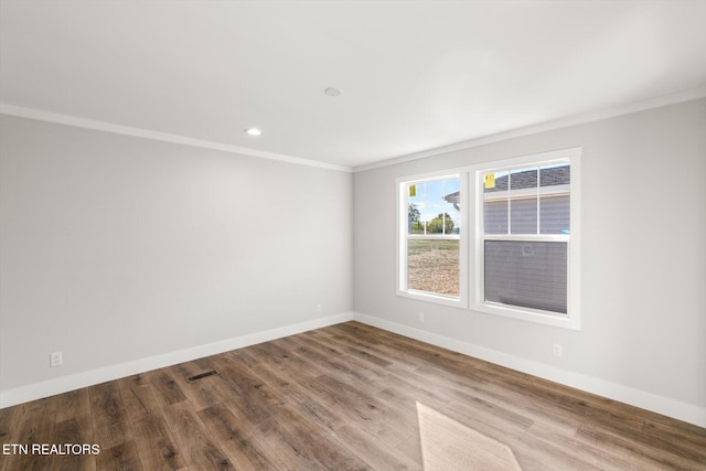 unfurnished room with wood-type flooring and crown molding