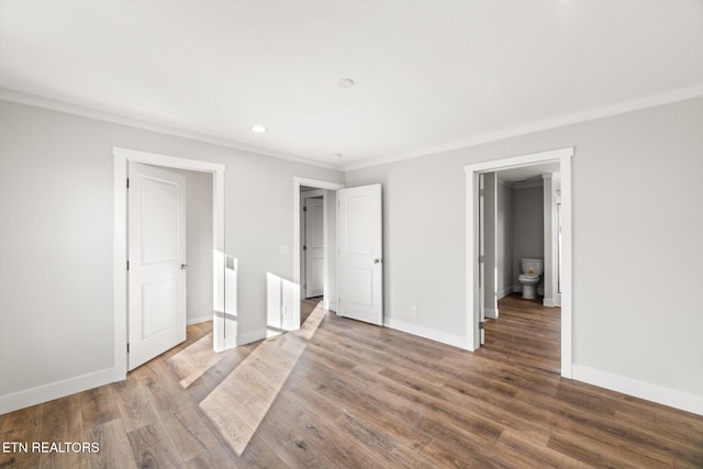 unfurnished bedroom featuring wood-type flooring and ornamental molding