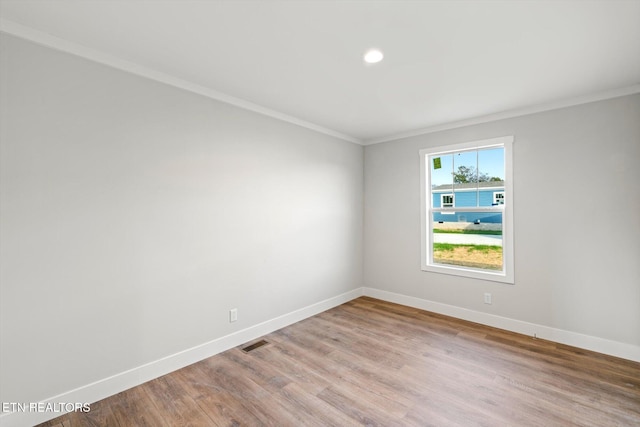 unfurnished room featuring light hardwood / wood-style flooring and ornamental molding