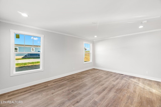 unfurnished room featuring light hardwood / wood-style floors and ornamental molding