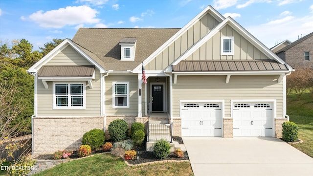 craftsman-style home with a shingled roof, concrete driveway, a garage, board and batten siding, and brick siding