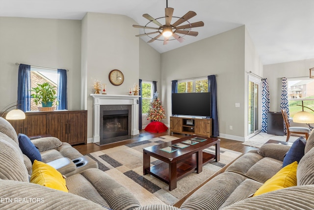 living room with high vaulted ceiling, light wood-type flooring, a wealth of natural light, and ceiling fan