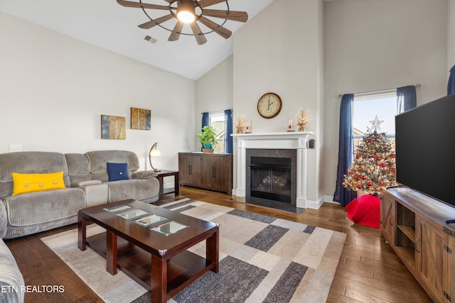 living room featuring high vaulted ceiling, ceiling fan, and dark hardwood / wood-style floors