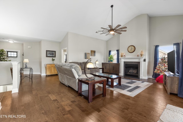 living room with high vaulted ceiling, ceiling fan, a healthy amount of sunlight, and dark hardwood / wood-style floors