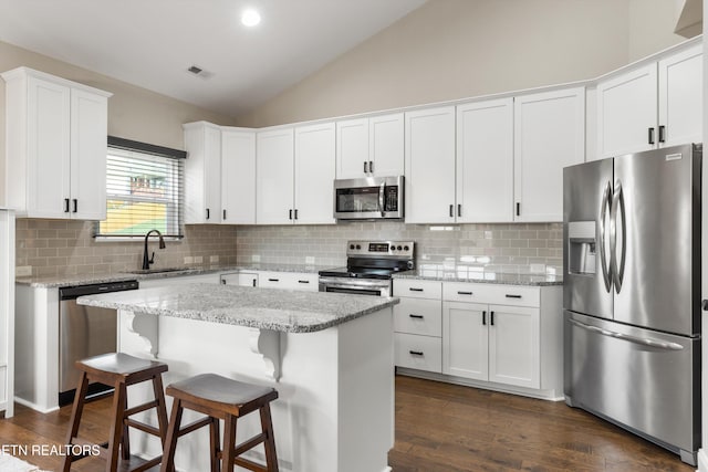 kitchen featuring a kitchen island, white cabinets, dark hardwood / wood-style floors, and stainless steel appliances