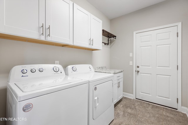 laundry area featuring cabinets and separate washer and dryer