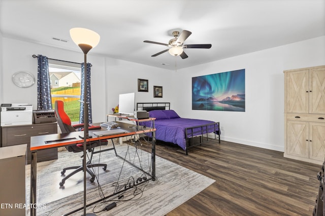 bedroom with dark hardwood / wood-style flooring and ceiling fan