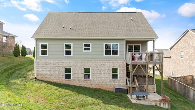 back of house with a lawn and a patio