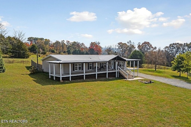 back of house with a lawn and a porch