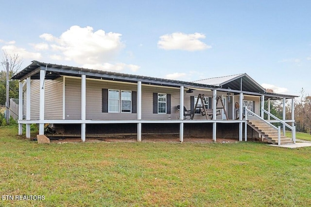 rear view of property featuring a yard