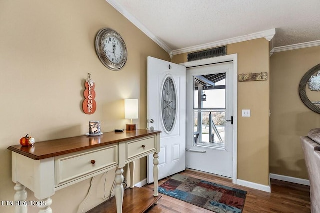 foyer entrance with hardwood / wood-style flooring, a textured ceiling, and crown molding