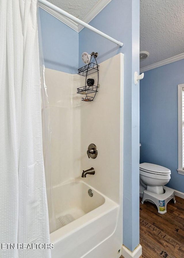 bathroom with shower / tub combo with curtain, wood-type flooring, ornamental molding, and a textured ceiling