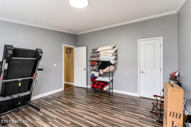 interior space featuring dark hardwood / wood-style floors, a textured ceiling, and crown molding