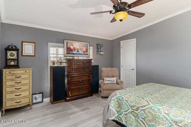 bedroom featuring ornamental molding, light wood-type flooring, and ceiling fan