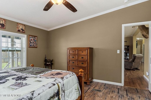 bedroom featuring dark hardwood / wood-style flooring, ceiling fan, and crown molding