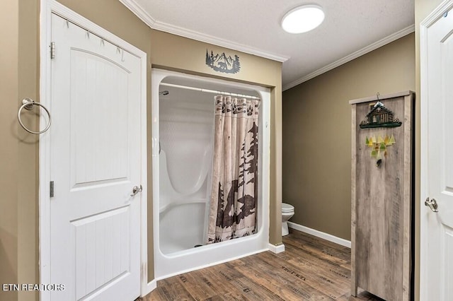 bathroom featuring hardwood / wood-style floors, curtained shower, and crown molding