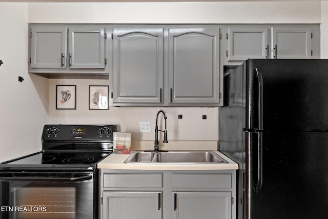 kitchen with sink, black appliances, and gray cabinetry