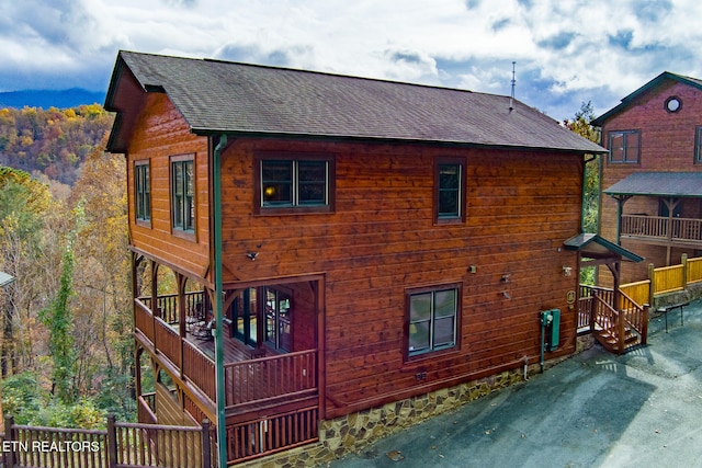 view of side of property featuring a wooden deck