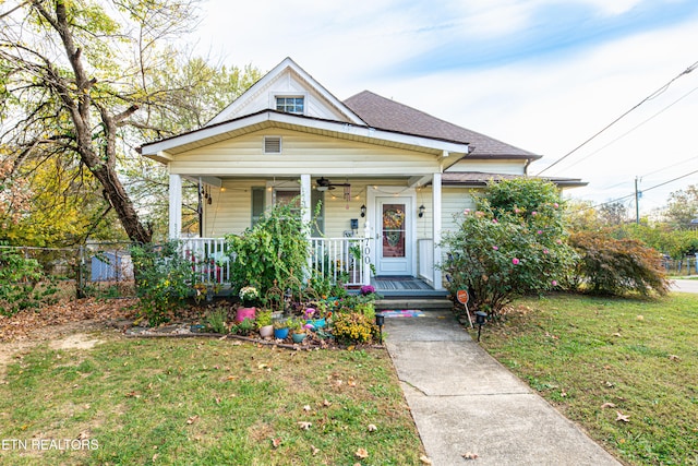 bungalow with a porch and a front yard