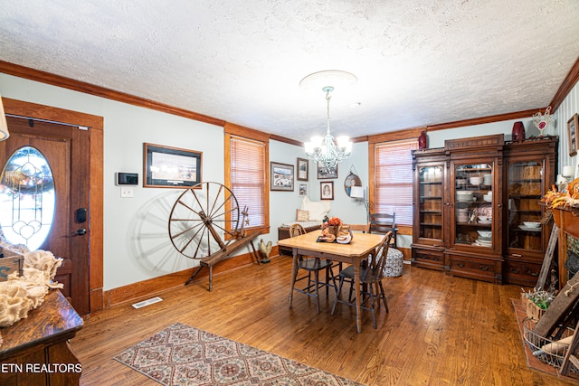 dining space with hardwood / wood-style flooring, a textured ceiling, and a wealth of natural light