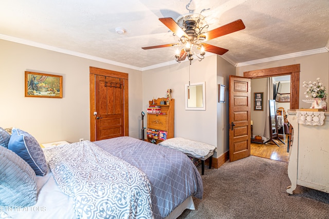 bedroom with a textured ceiling, carpet, ceiling fan, and crown molding