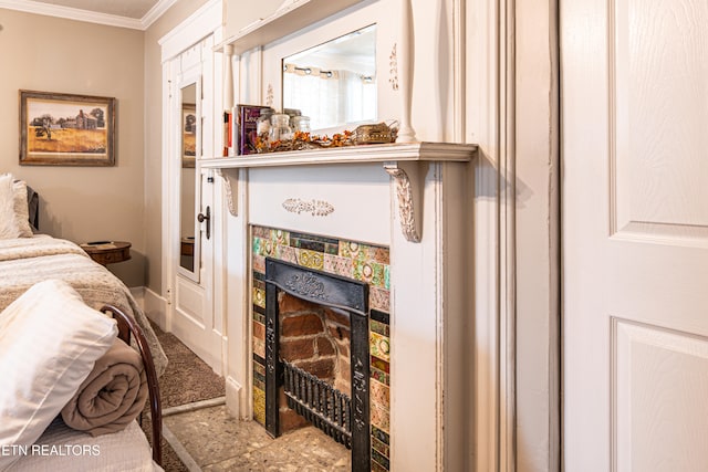 interior space featuring a tiled fireplace and crown molding