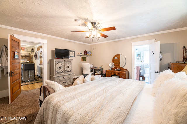 bedroom with ornamental molding, wood-type flooring, ceiling fan, and connected bathroom