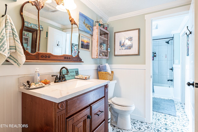 full bathroom featuring crown molding, vanity, a textured ceiling, toilet, and tiled shower / bath