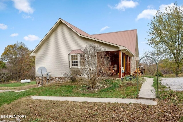 view of property exterior with a yard